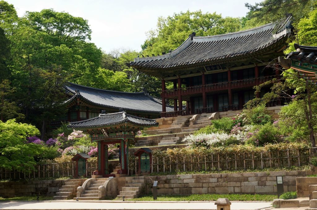 Juhamnu Pavilion at Buyongji Pond in Changdeokgung Secret Garden, two-story traditional Korean pavilion beside square pond with round island, pond reflection